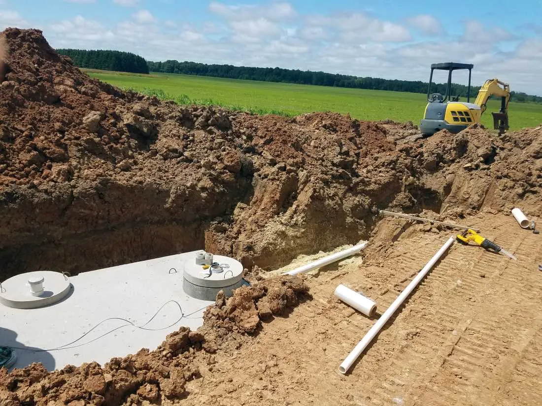 Concrete septic holding tanks being buried for a new home construction